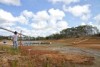 Colin Ward stands on the banks of a small dam running dry.