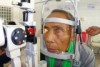 A Cambodian man with cataracts is given an eye test