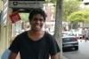 A young man stands in a street in Sydney