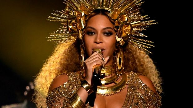 In a display of regal brilliance, a heavily pregnant Beyonce performs at the Grammys.