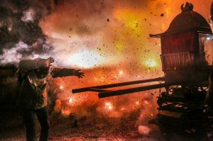 TAINAN, TAIWAN - FEBRUARY 10: People wearing helmets get sprayed by fire sparks during the Yanshui Beehive Rockets ...