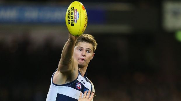 MELBOURNE, AUSTRALIA - SEPTEMBER 20:  Nathan Vardy of the Cats taps the ball out of the ruck against Jarryd Roughead of the Hawks  during the AFL First Preliminary Final match between the Hawthorn Hawks and the Geelong Cats at the Melbourne Cricket Ground on September 20, 2013 in Melbourne, Australia.  (Photo by Quinn Rooney/Getty Images)