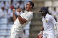 Mitchell Starc celebrates the wicket of Dimuth Karunaratne early on day one at Pallekele.