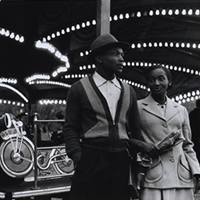 Lewis Morley Black couple and carousel at Hampstead fun fair c.1959 National Gallery of Australia, Canberra © Lewis Morley