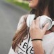 A woman with headphone around her neck.