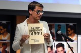 Milo Yiannopoulos holds a sign as he speaks at the University of Colorado campus in Boulder, Colorado. 