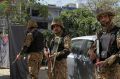 Pakistani soldiers stand alert at the site of an explosion, in Lahore, Pakistan.