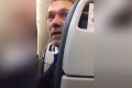 An image from a video a passenger on the United flight filmed of a man and woman being escorted off of the plane after ...
