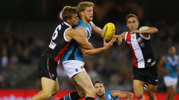 Saint Jack Newnes tackles Port Adelaide's Matthew Lobbe.