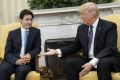 President Donald Trump, right, extends his hand to Justin Trudeau, Canada's prime minister, during a meeting in the Oval ...