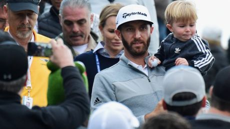 PACIFIC PALISADES, CA - FEBRUARY 19: Dustin Johnson and his son Tatum walk down to the 18th hole during the final round ...