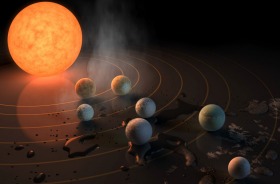 An artist's concept of the TRAPPIST-1 star, an ultra-cool dwarf, with its seven Earth-size planets orbiting it.