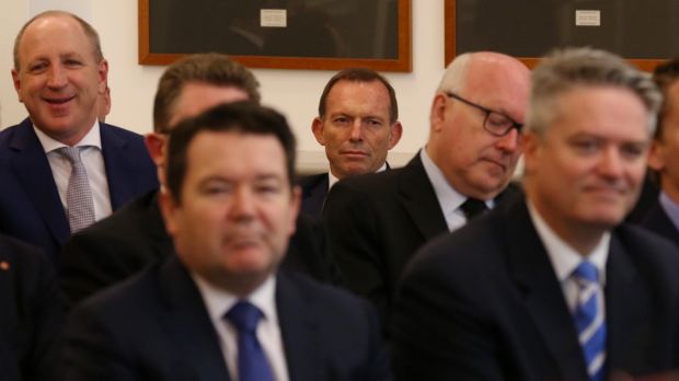 Tony Abbott listens to Prime Minister Malcolm Turnbull addressing the party room at Parliament House in November.