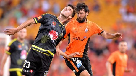 Head-to-head: Thomas Broich of the Roar and Matthew Ridenton of the Phoenix challenge for the ball.