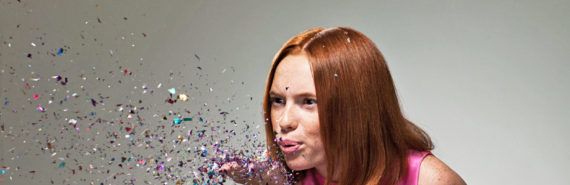 woman blows confetti