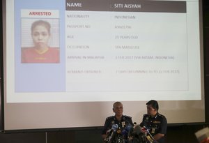 Royal Malaysian Police deputy inspector-general Noor Rashid Ibrahim, center left,  speaks about detained Indonesian suspect Siti Aisyah