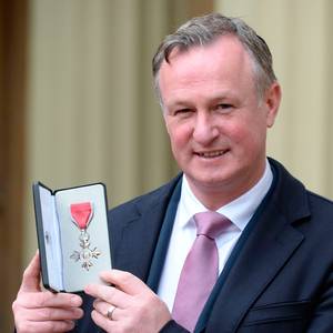 Northern Ireland manager Michael O'Neill poses with his medal after being appointed a Member of the Order of the British Empire (MBE) by Britain's Queen Elizabeth II at an investiture ceremony at Buckingham Palace in London on February 23, 2017. AFP/Getty Images