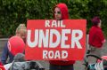 A protester at a rally against a sky rail on the Frankston train line. 