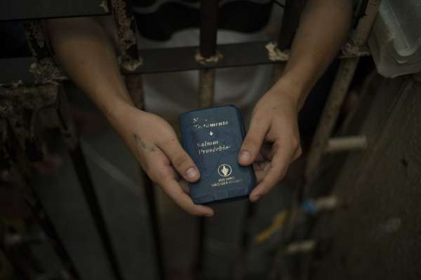 In this Feb. 6, 2017 photo, a detainee holds a Bible inside an overcrowded cell at a police station near Manaus, Brazil. A recent study by think-tank Fundacao Getulio Vargas estimates that 40 percent of Brazilian prisoners have not been convicted.