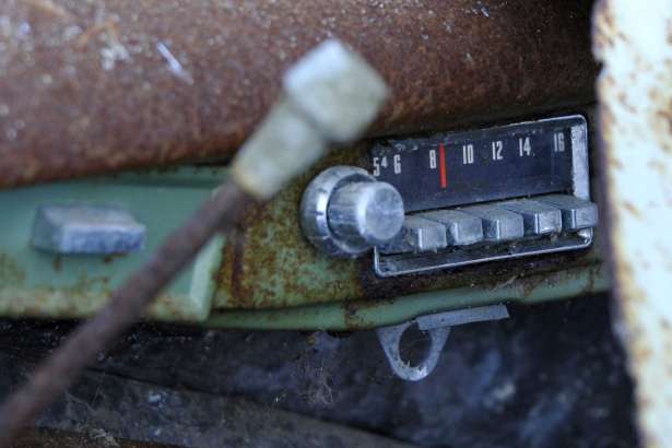 The push button radio still tuned to an 800 frequency on the AM dial on a Jeep Wagoneer that was salvaged Friday, Feb. 24, 2017, in Truro, Mass. Work crews early Friday pulled out the rusted remnants of what John Munsnuff says was once his family’s “beach buggy” at the home they’ve long owned near Ballston Beach in Cape Cod. (Steve Heaslip/The Cape Cod Times via AP)