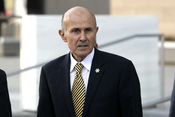 FILE - In this Dec. 19, 2016 file photo, former Los Angeles County Sheriff Lee Baca leaves federal court in Los Angeles. Baca went on trial on federal corruption charges Friday, Feb. 24, 2017, stripped of a ceremonial badge and unable to present a defense that might have won him sympathy if jurors knew he was in the early stage of Alzheimer's disease. Instead, his lawyer dropped only a hint of what he couldn't say as he attacked the obstruction of justice and lying charges as an outgrowth of a rookie FBI investigation riddled with blunders.