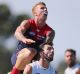  James Harmes of the Demons leaps on Simon White of the Blues for a high mark attempt during the JLT Community Series match.