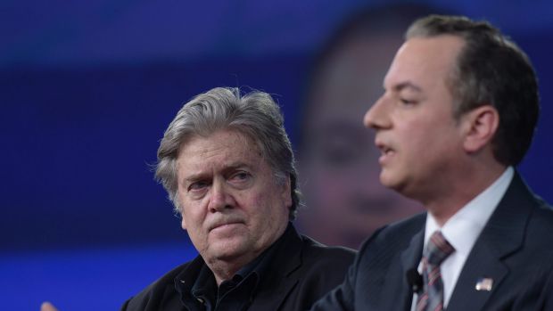 White House strategist Stephen Bannon listens as Reince Priebus speaks.