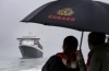 Remaining regal despite the torrential rain, the remastered QM2 arrives in Southampton Water.