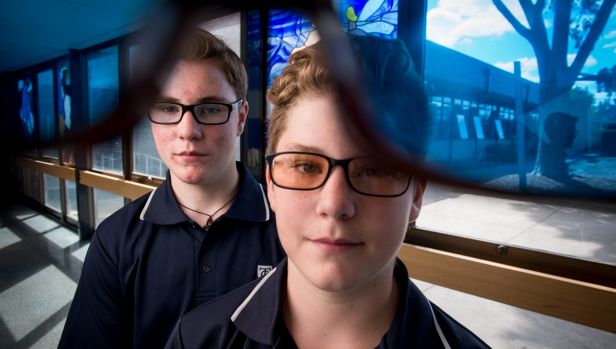 14 year old Silas Dewdney and his 12 year old brother Noah Dewdney say their colored glasses have helped with their dyslexia enormously. For them, they stop the words jumping around on the page. The blue pair are an old pair. PHOTO: PENNY STEPHENS. The Age. 23RD FEBRUARY 2017