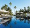 Sun loungers and parasols by the pool at Vomo Island Resort.