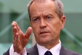 Upper body photo of Bill Shorten pointing directly ahead as he speaks.