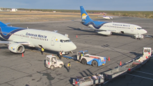 Canadian North planes being emptied of luggage at the Yellowknife airport