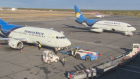 Canadian North planes being emptied of luggage at the Yellowknife airport