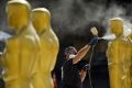 Scenic artist Rick Roberts paints Oscar statues for Sunday's 89th Academy Awards red carpet in Los Angeles.
