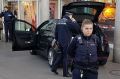 A car stands in front of a store, guarded by police in Heidelberg, Germany, on Saturday.