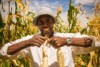 Joel Sindayigaya holds freshly harvested maize. 