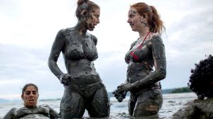 Women wade in a pool of mud during the traditional "Bloco da Lama" or "Mud Street" carnival party, in Paraty, Brazil, ...