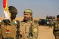 Fighters of the Popular Mobilisation Forces stand at the front line outside Mosul in November.