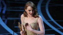 Best Actress winner Emma Stone holds her hand on her heart as she accepts her award for La La Land. 