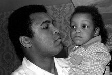 Muhammad Ali holding his 2 year old son  Muhammad Ali in 1975. 