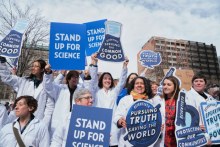 Group of scientists hold signs at the Stand up for Science rally in Boston's Copley Square