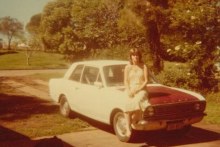 Tracey Walker sitting on one of her cars in 1979.