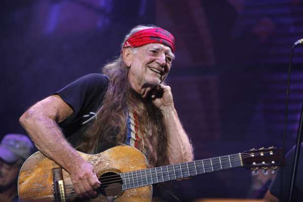 FILE - In this Sept. 9, 2007, file photo, Willie Nelson performs at Farm Aid on Randall's Island in New York.   Nelson, the children of the late reggae icon Bob Marley and comedian Whoopi Goldberg are just a few of the growing number of celebrities publicly jumping into the marijuana industry and eyeing the California pot market.