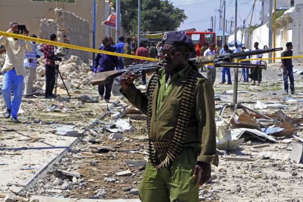 FILE - In this Jan. 2, 2017, file photo, a Somali soldier patrols the area of a suicide car bomb attack in Mogadishu, Somalia. The Pentagon wants to expand the military’s ability to battle al-Qaida-linked militants in Somalia, potentially putting U.S. forces closer to the fight against a stubborn extremist group that has plotted attacks against America, senior U.S. officials said.