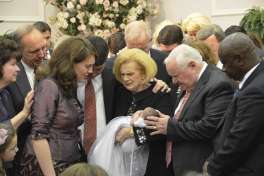 In this 2012 photo provided by a former member of the church, Word of Faith Fellowship leader Jane Whaley, center, holds a baby, accompanied by her husband, Sam, center right, and others during a ceremony in the church's compound in Spindale, N.C. From all over the world, they flocked to this tiny town in the foothills of the Blue Ridge Mountains, lured by promises of inner peace and eternal life. What many found instead: years of terror _ waged in the name of the Lord.