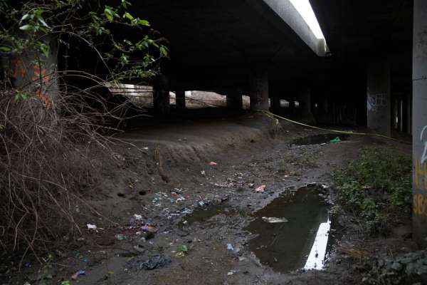 Police tape is all that's left of police presence the morning after a mass shooting at "The Jungle," a homeless encampment under Highway 5 in Sodo, on Wednesday, Jan. 27, 2016.