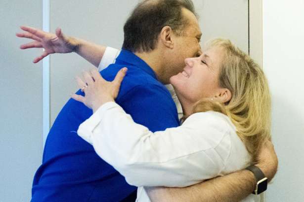 In a Feb. 23, 2017 photo, Dr. Brian Dunn, left, and Dr. Colleen Coleman reunite at Hoag Hospital in Newport Beach, Calif., to see each other for the first time since she donated her kidney to him. The two have been friendly more than a decade while working together. Coleman is a surgeon and Dunn is an anesthesiologist at Hoag Hospital Newport Beach. (Cindy Yamanaka/The Orange County Register via AP)