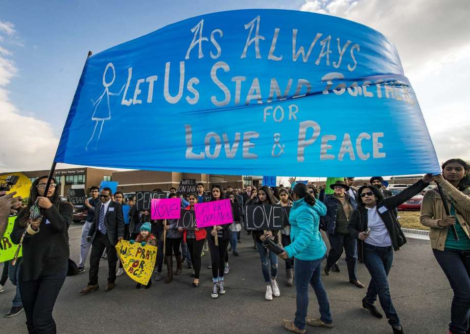 Hundreds of people march for peace on Sunday, Feb. 26, 2017, around the Ball Conference Center in Olathe, Kan., before starting a prayer vigil in response to the deadly shooting Wednesday. Adam Purinton was arrested hours after the attack and accused of shooting two Indian immigrants and a third man at a bar, in what some believe was a hate crime. (Allison Long/The Kansas City Star via AP) Photo: Allison Long, AP / The Kansas City Star