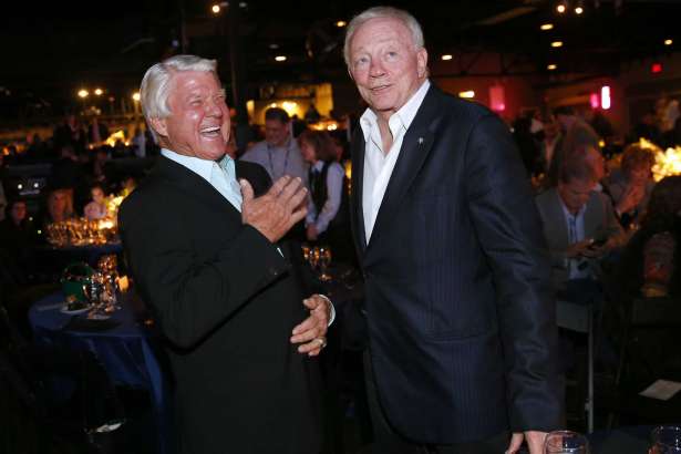 Dallas Cowboys owner Jerry Jones, right, and his former Super Bowl-winning coach Jimmy Johnson laugh following the 25th Anniversary of Super Bowl XXVII at Gilley's in Dallas, Saturday, Feb. 25, 2017. (Tom Fox/The Dallas Morning News via AP)