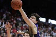 Washington State guard Malachi Flynn (22) and Washington forward Sam Timmins go after the ball during the first half of an NCAA college basketball game in Pullman, Wash., Sunday, Feb. 26, 2017.